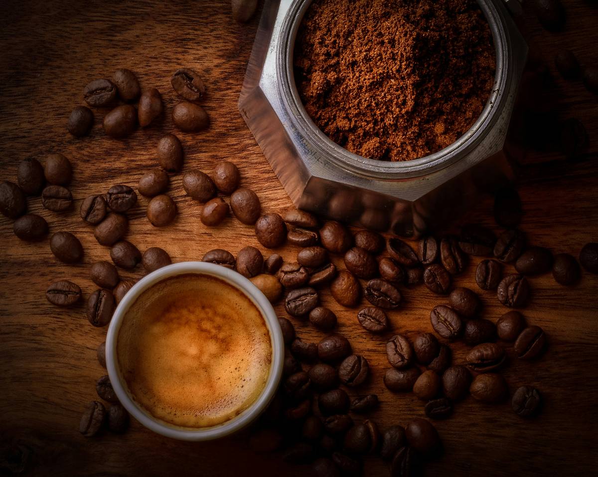 The hottest home coffee maker on a modern kitchen counter with smartphone displaying brewing status